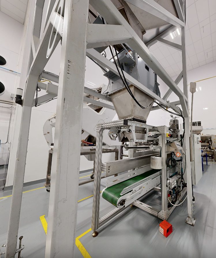 Manual bagging line with net weigh scale and sew head